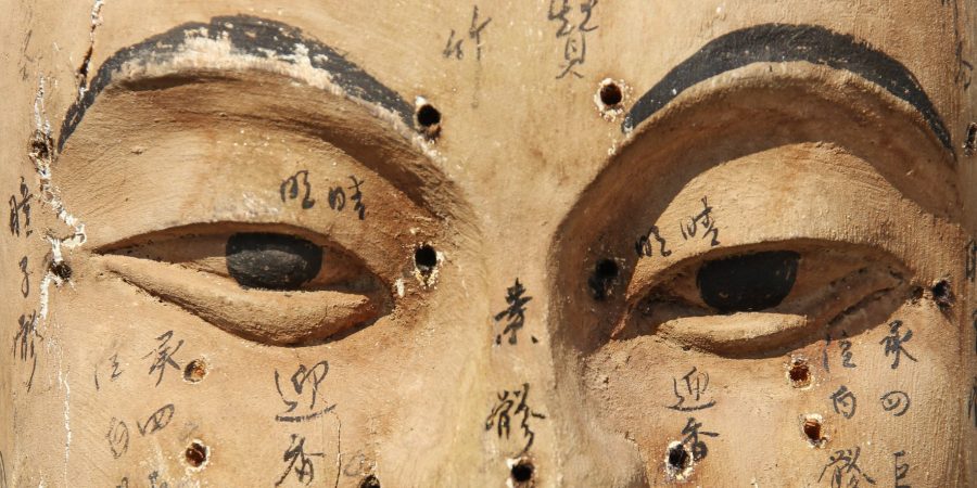 Ancient wooden face showing acupuncture points